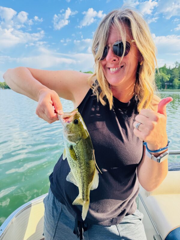 Angler giving a thumbs up with a largemouth bass