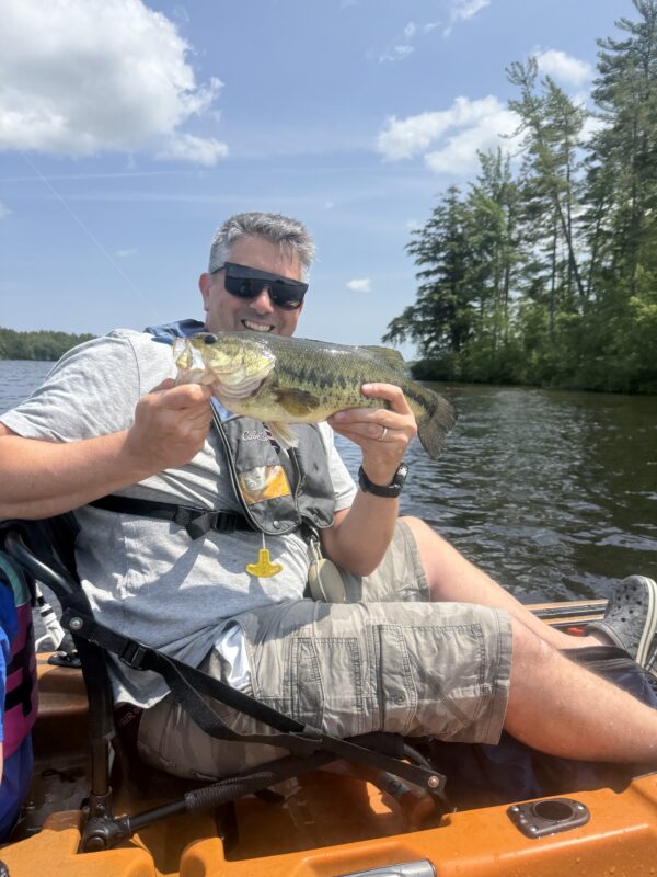 Kayak angler with a largemouth bass
